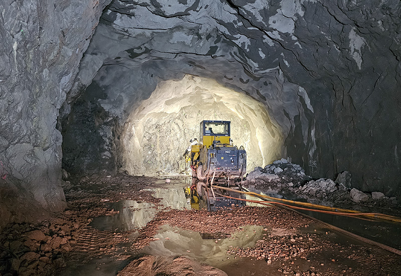 Bilden visar en borrmaskin i en bergtunnel under jord